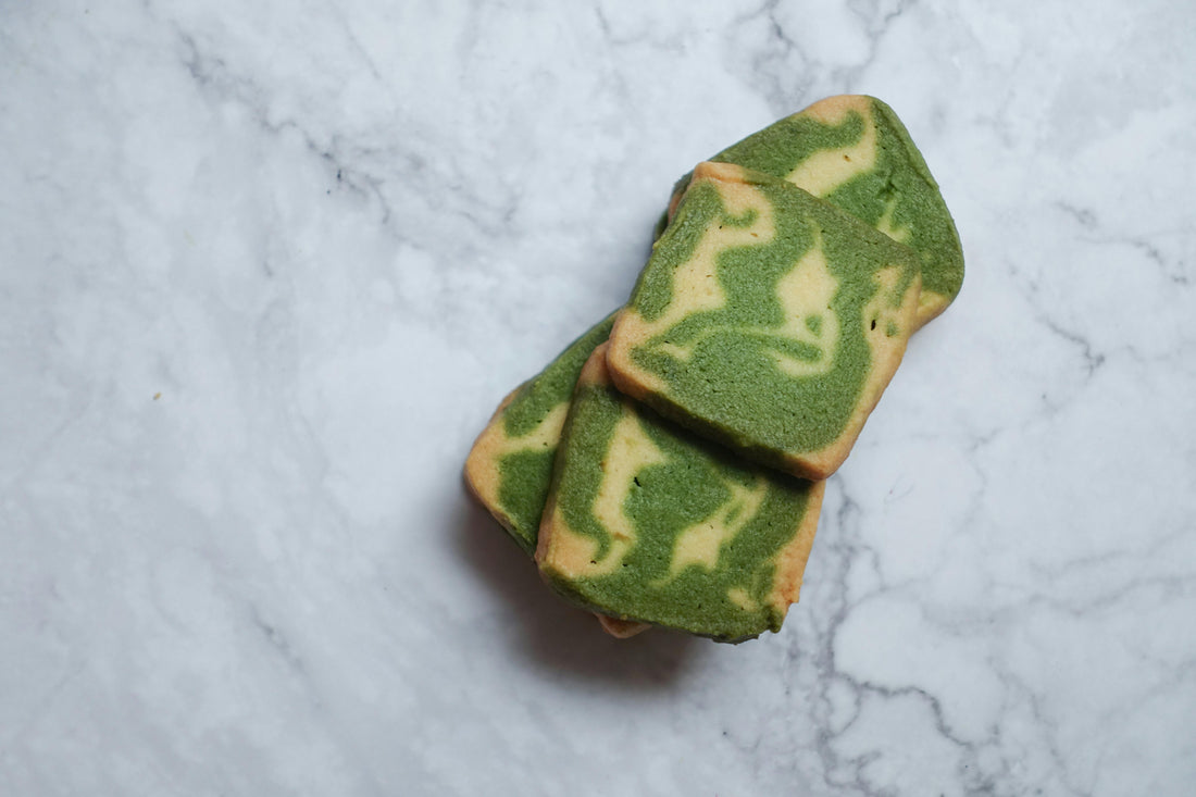 Vanilla matcha pound cake loaf on marble countertop