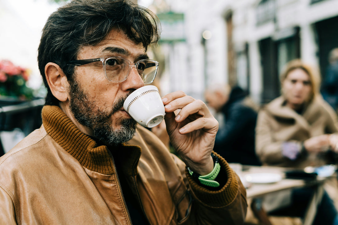 Italian man drinking espresso coffee from a small cup in Italy