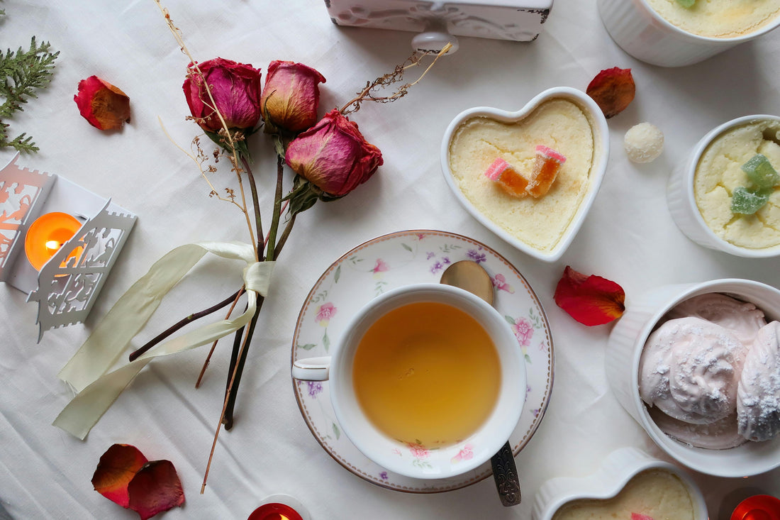 Tea with roses and sweet pastries arranged for a Valentine's Day date