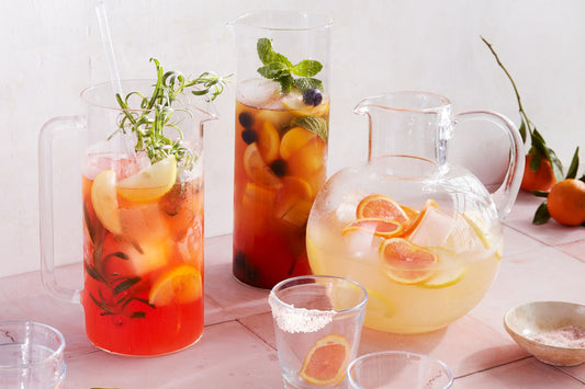 Different refreshing iced tea mixes shown in pitchers